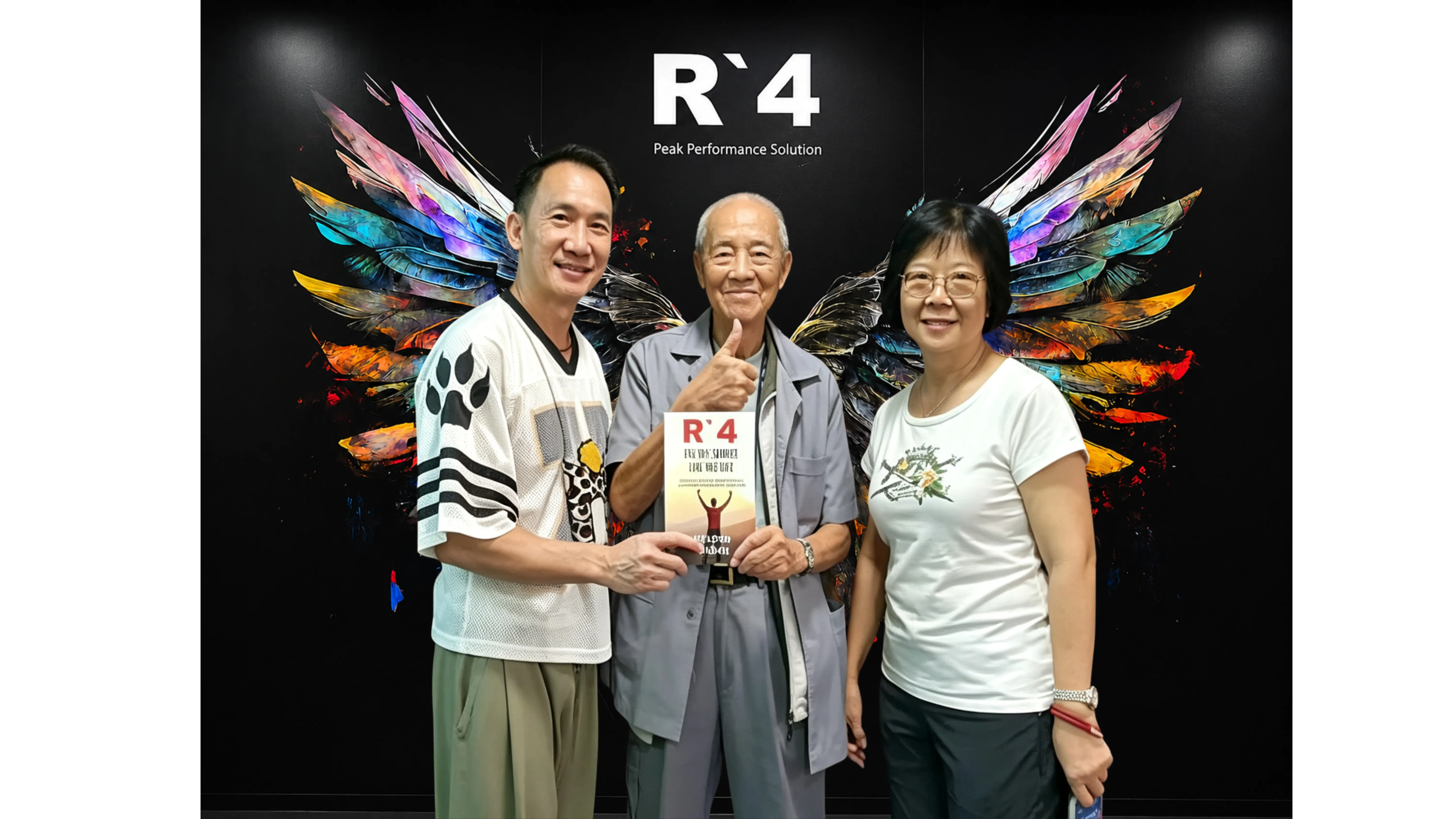 Nelson Chong with an older couple holding an R4 book at FTI